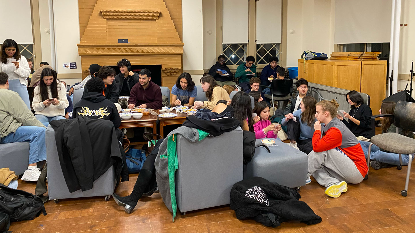 Students gather for a community dinner.