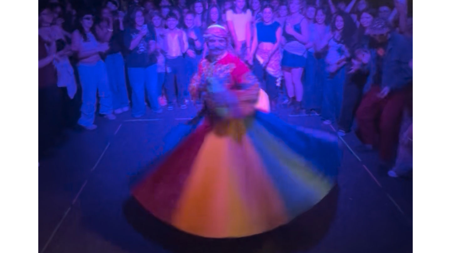 A whirling dervish at an Arabic dance party.