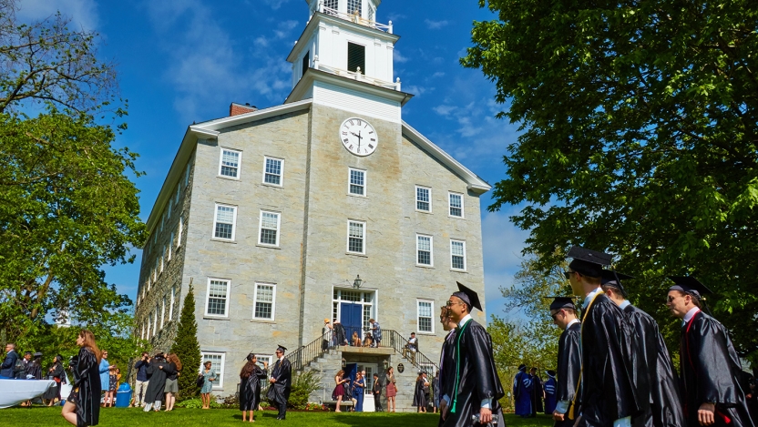 Graduates and guests mingle on the lawn in front of Old Chapel.
