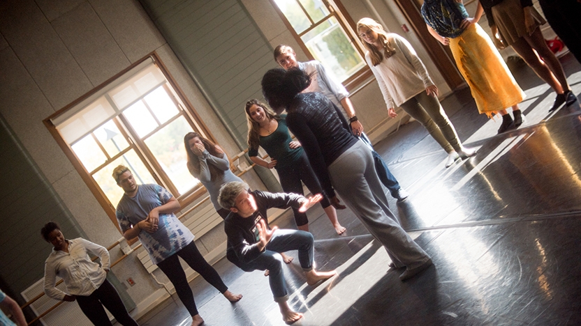A dance instructors advises students in the dance studio.