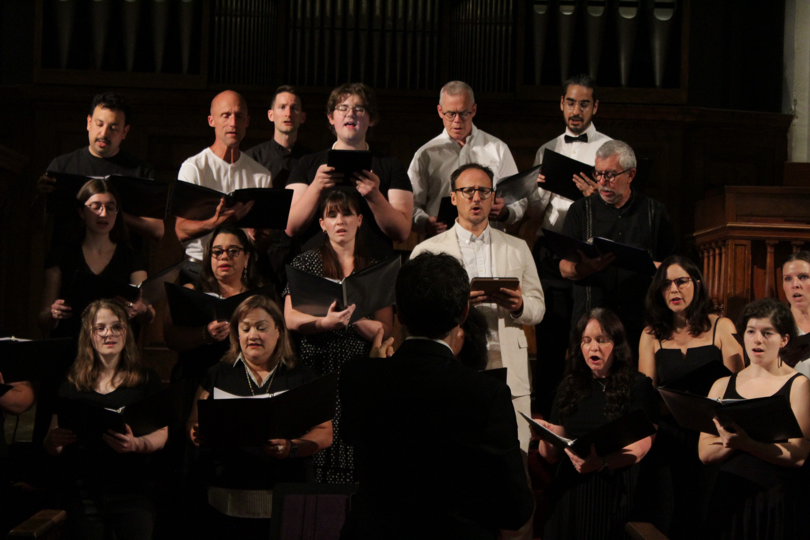 A mixed choir sings in concert.
