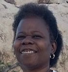 a woman smiles at the camera.