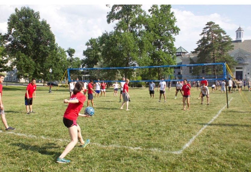 Students participate in a volleyball game on the Middlebury Campus.