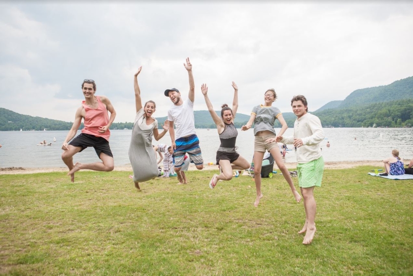 Students jump in front of Lake Dunmore in Vermont.