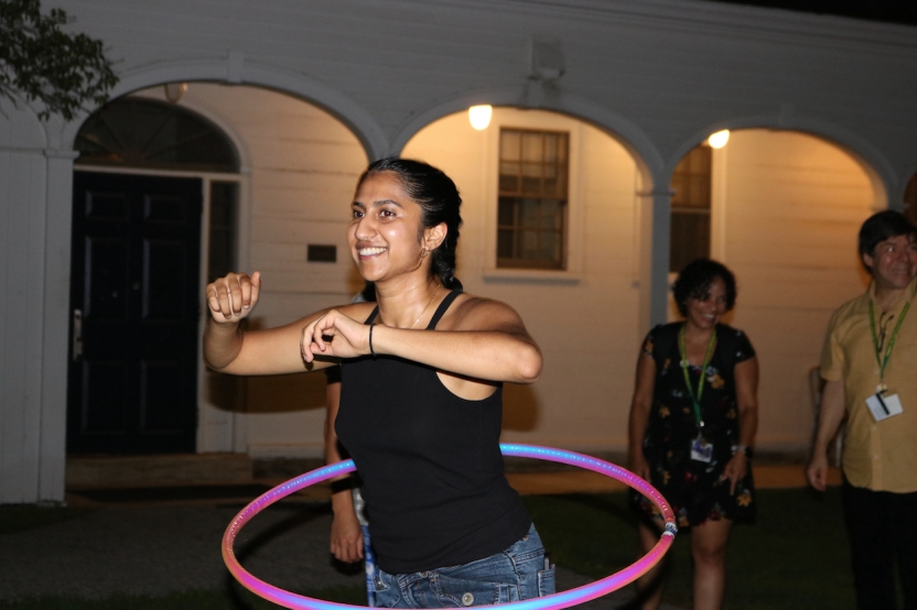 A student uses a hula hoop outside.