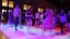 Large group of spanish language school students dancing in large group.