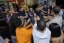 A group of people joins their hands together for a cheer.