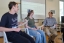 Students laugh in class, sitting at the front of the room.