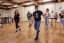 A group of people learn to dance bachata.