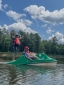 Students use a paddle boat on the lake.