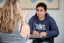 A student in a Middlebury sweatshirt talks to a classmate.