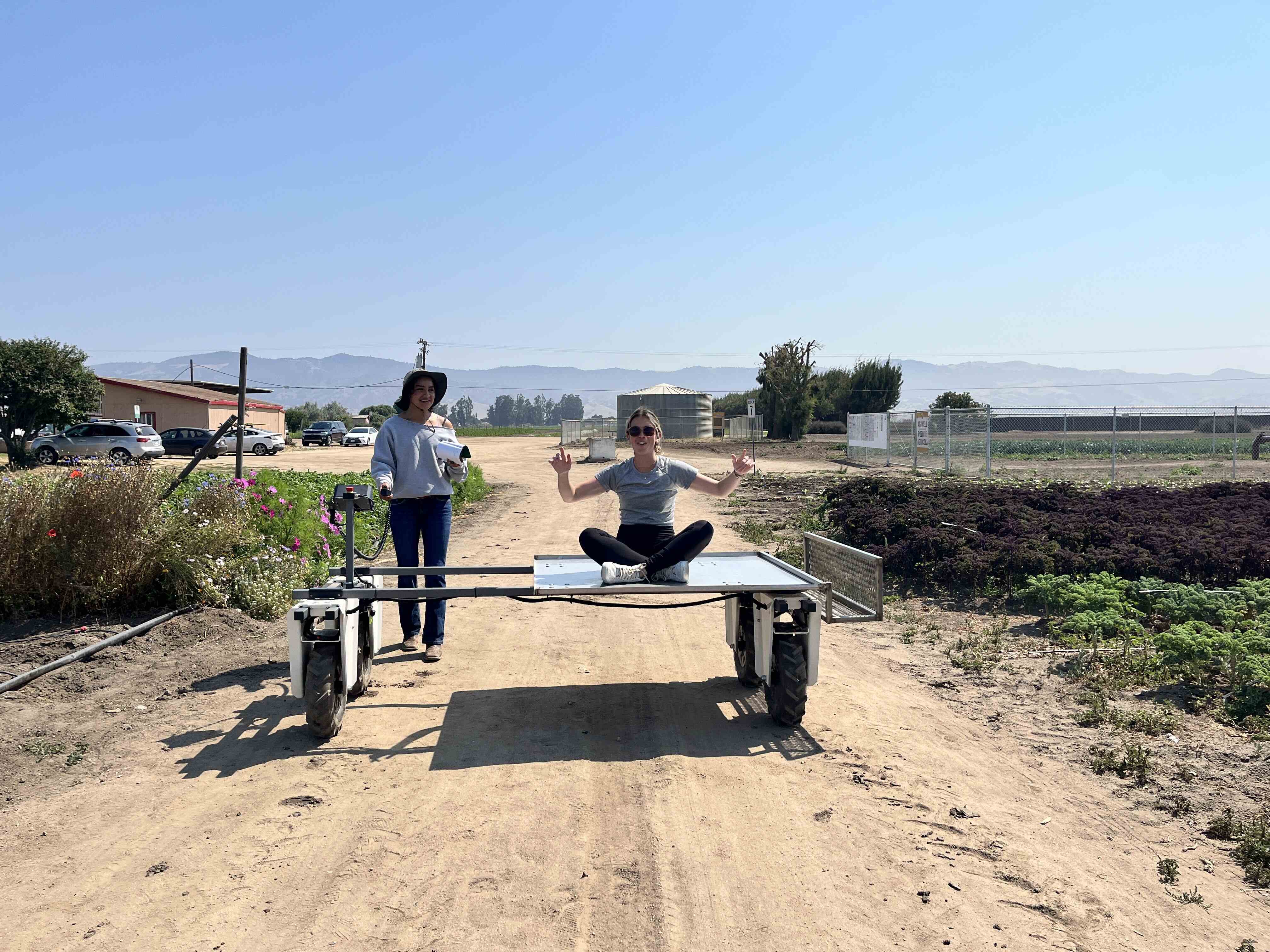 Student sitting on a piece of farm equiptment
