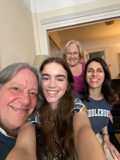 A student smiling for a selfie with their host family and program staff