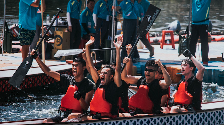 Rowers celebrating after a dragon boat race at NSYSU.