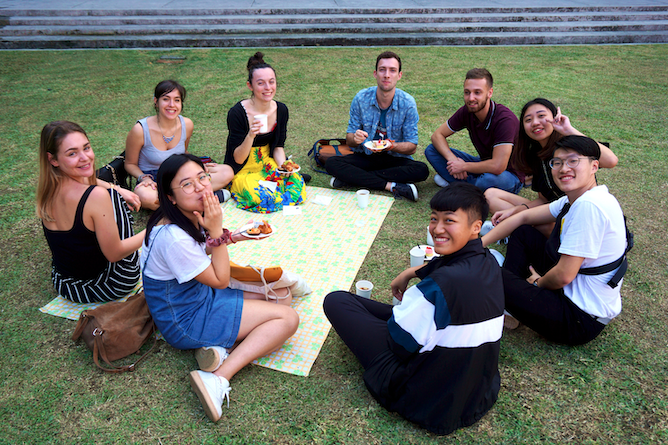 Students having a picnic on the lawn at NSYSU