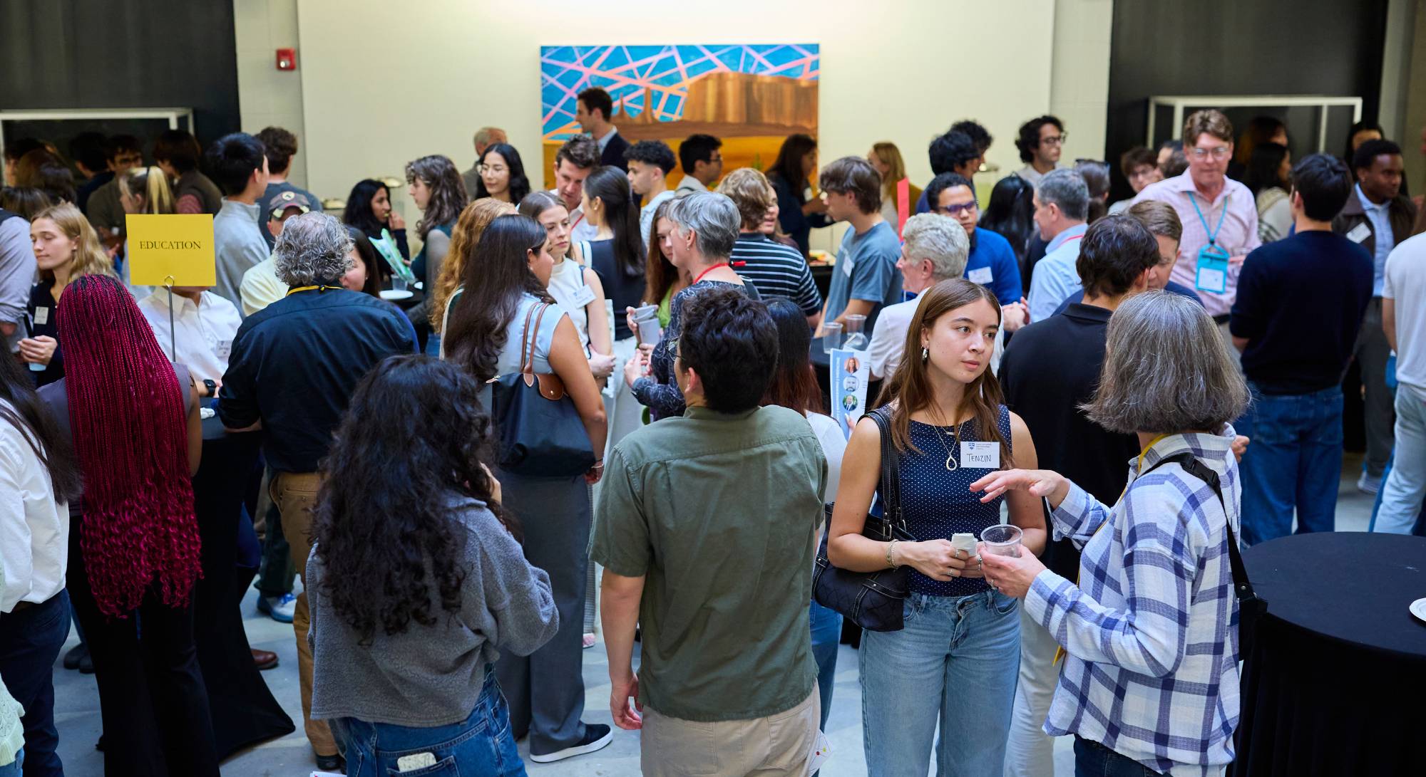 A photo of the group of parents, alumni, and students networking.