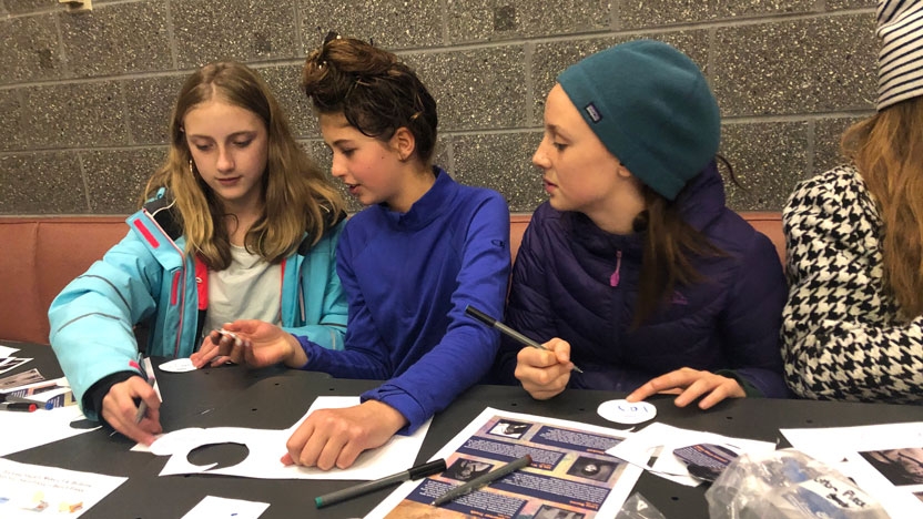 Participants of the Sister-to-Sister Program make buttons commemorating the leaders of the movement that advocated for women's right to vote.