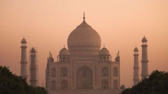 India building Taj Mahal at sunset