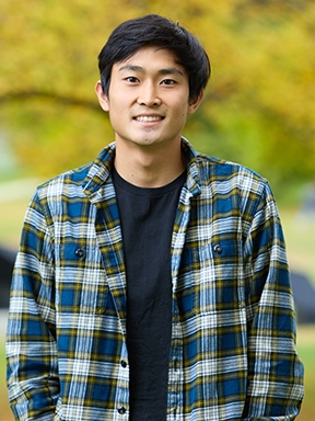 portrait of Noah Lee ’26 in a black shirt and flannel.