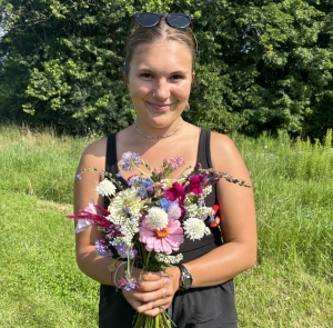 Knoll intern holding bouquet of flowers