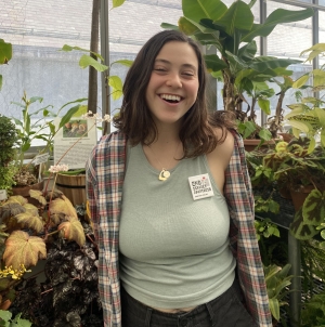 Smiling Knoll Intern in a greenhouse