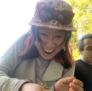 Profile photograph of Knoll intern holding a frog and looking down