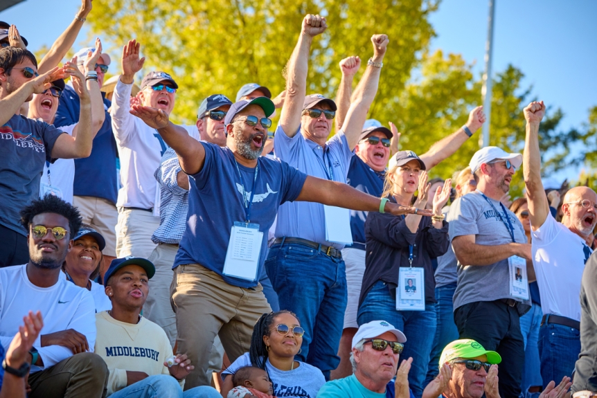 Students and families cheer on the Middlebury football team during Fall Family Weekennd.