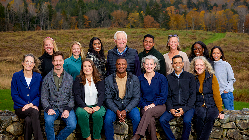 Board members of the Middlebury Alumni Association outdoors on the Breadloaf Campus at a 2023 fall retreat