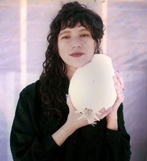 Photo of artist Estefania Puerta holding a sculpture.
