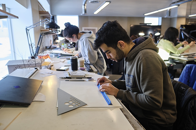 Students in a classroom work on an architecture project.