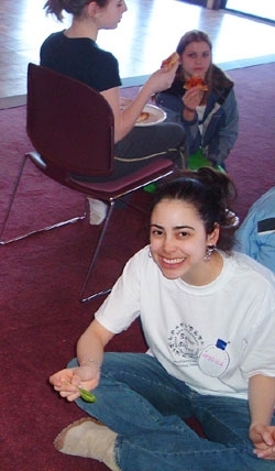 Summit intern Jessica Levin has a seat during the summit luncheon, provided by Vermont-based pizza manufacturer American Flatbread.