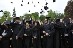 Middlebury College class of 2011 celebrates with caps in the air.