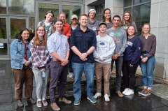 Biology professor Greg Pask is surrounded by his students outside McCardell Bicentennial Hall.