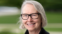 Head shot of Michelle McCauley smiling with glasses.