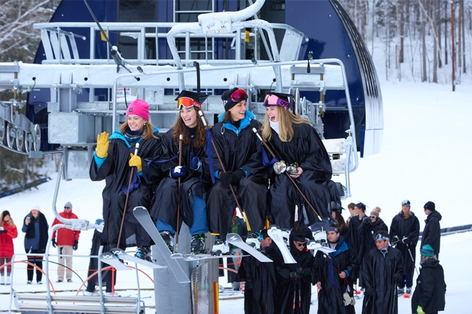 Four students ride the chairlift at the Snowbowl.