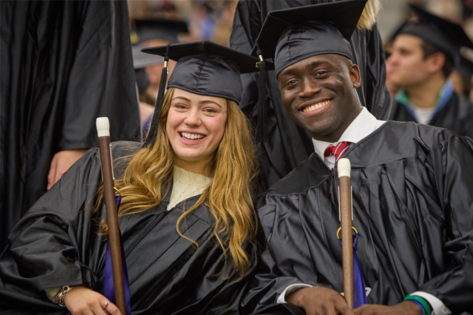Two Feb graduates smile with their canes at Feb Celebration.