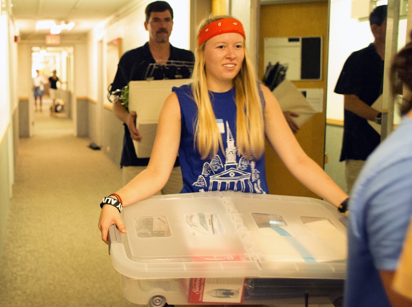 girl_carries_box_hallway