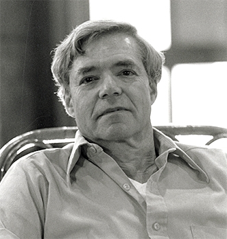 Photo of Professor Robert Pack sitting in a chair.