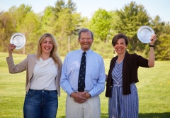 Professors Caitlin Myers and Sara Stroup with alum Hugh Marlow outside on the Middlebury campus.