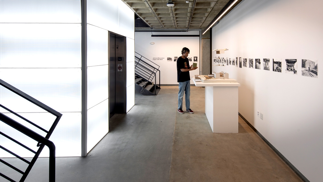 A student looking at art inside the new Christian A. Johnson Memorial Building and campus. Photo: © David Sundberg/Esto