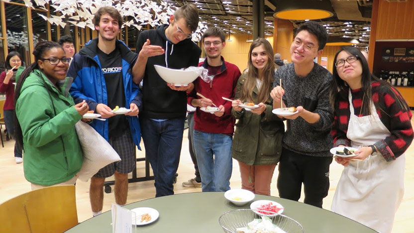 Seven students enjoy eating the sushi they made.