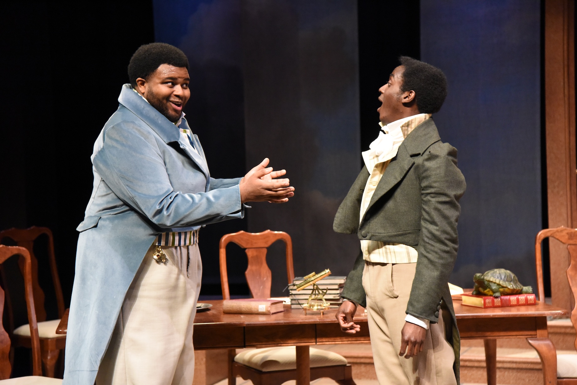 Two actors in fine clothing talking