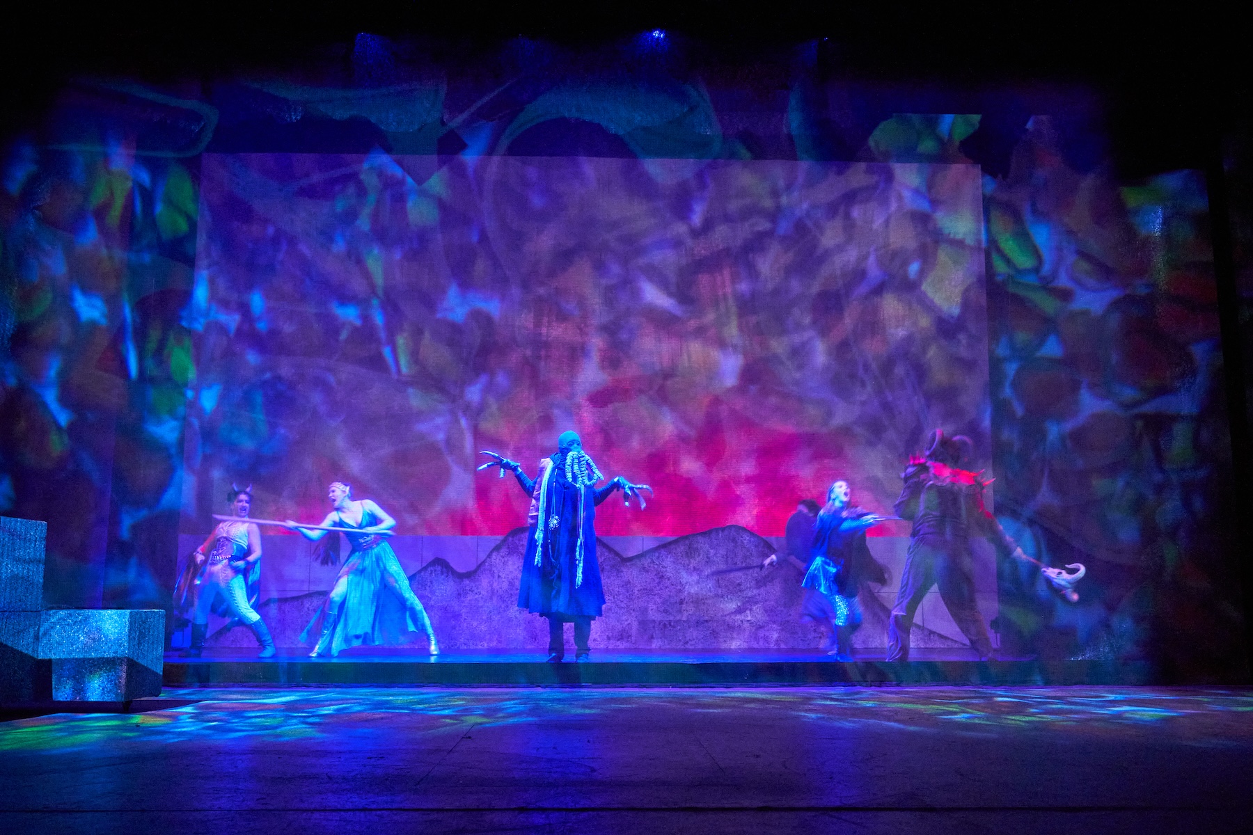 Monster center stage with battle happening around it