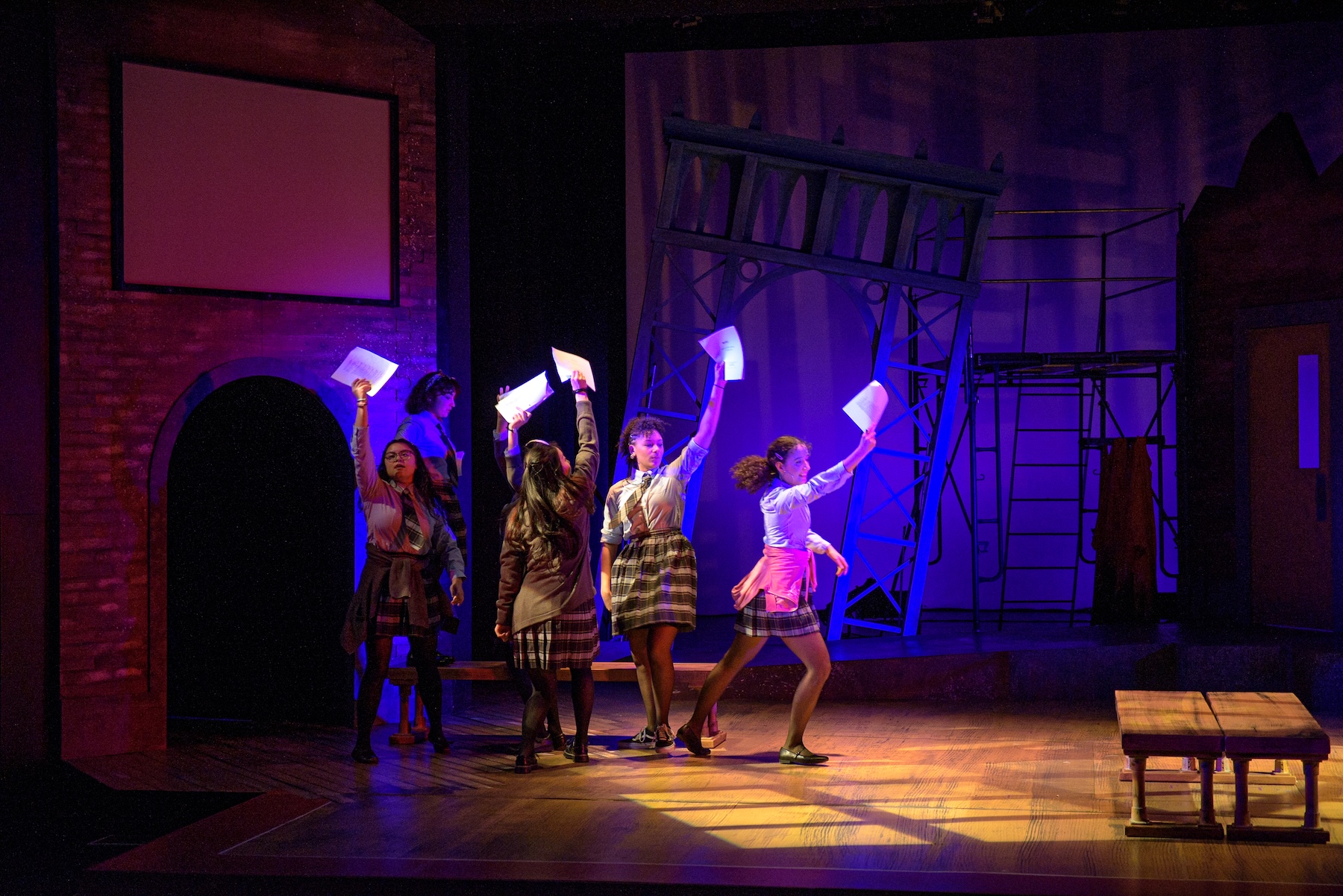 Actors dancing with papers in hand