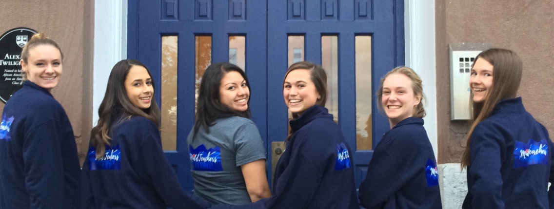 Alumni pose outside Twilight Hall.