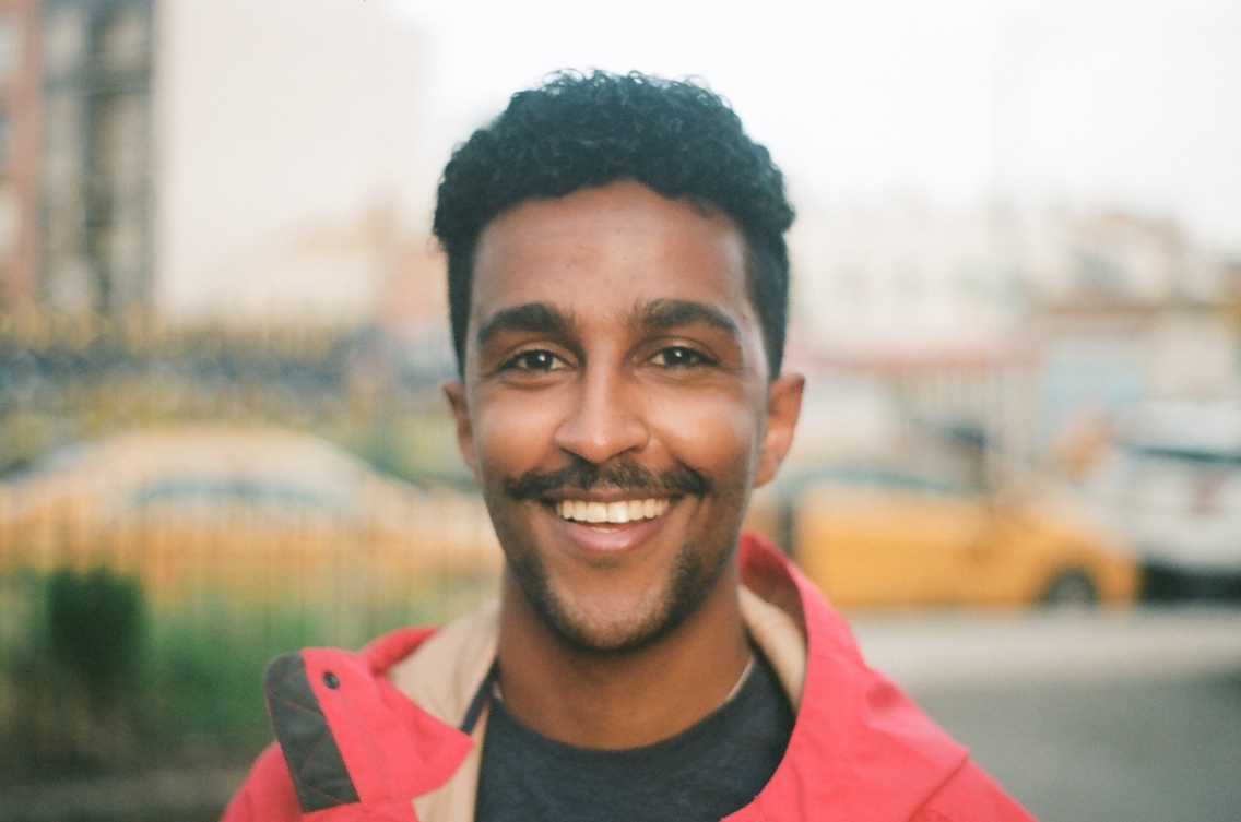 Person with mustash and red coat