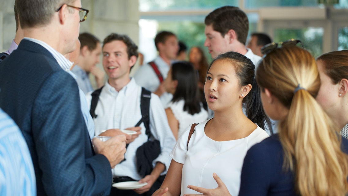 Students participate in a networking session with professional in the business consulting field.