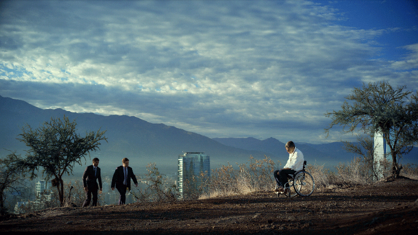 Man in wheelchair on top of hill.