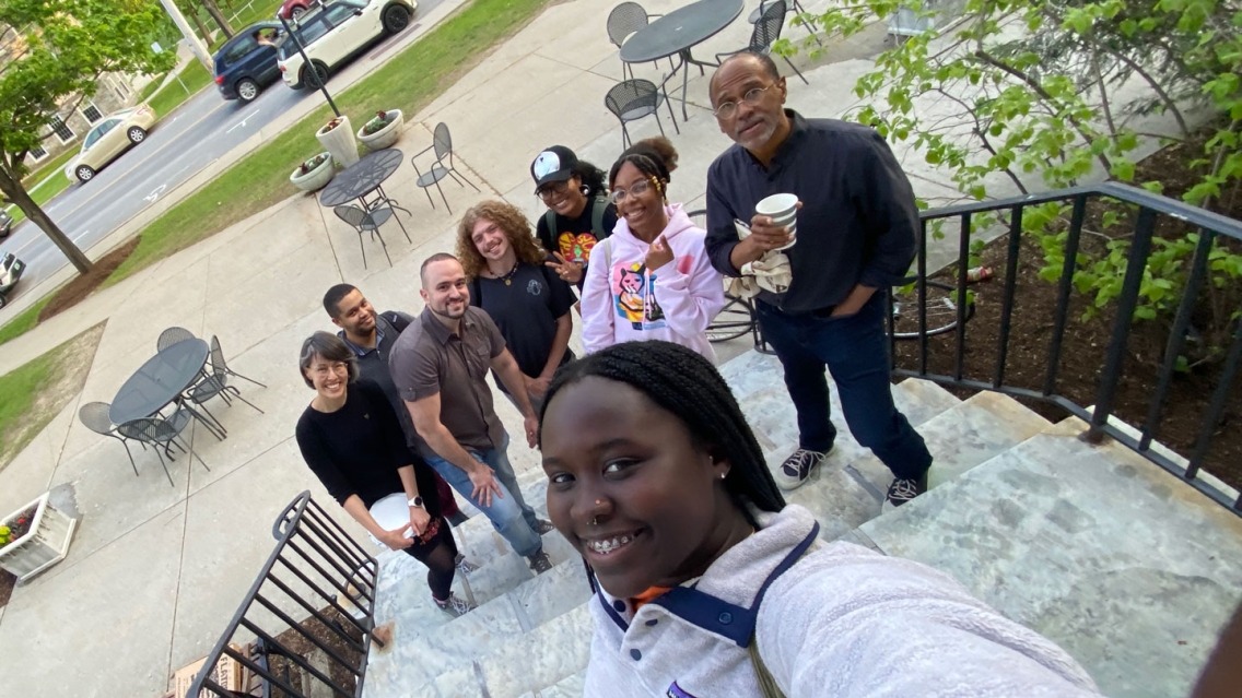 Several students in the Black Studies department taking a selfie outside Proctor Dining Hall..