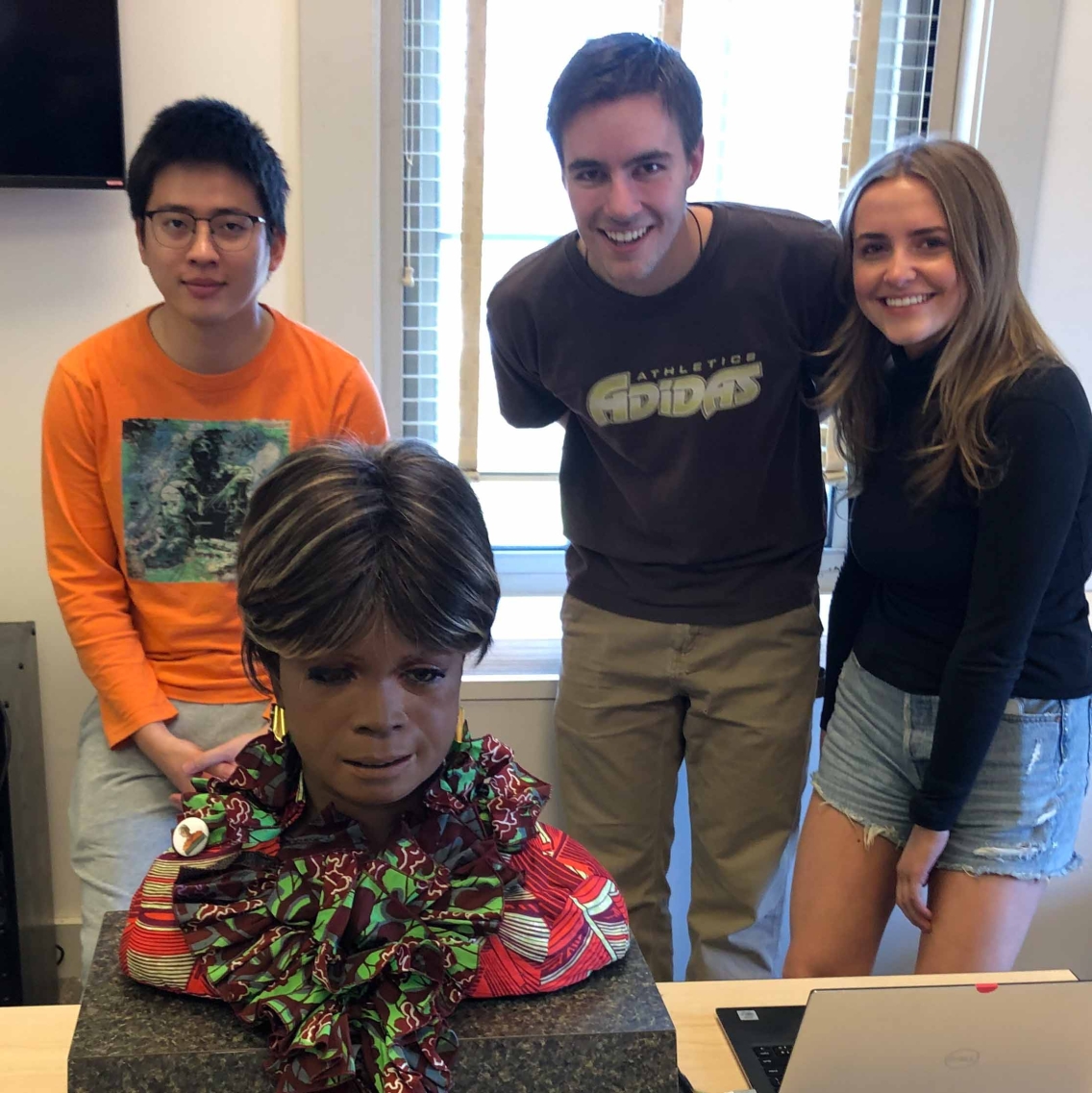 students with creepy robot head